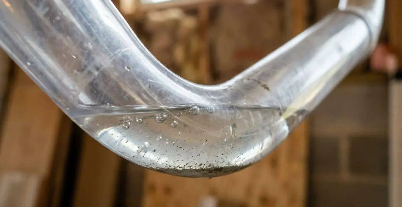 Installation incorrecte d'un tuyau d'évacuation de climatisation montrant une contre-pente